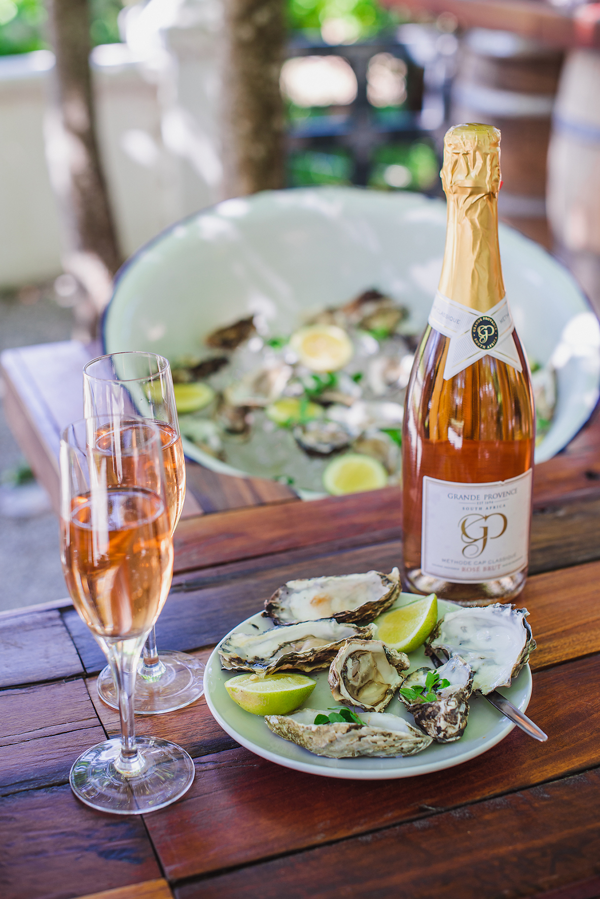 Grande Provence MCC and Oyster tasting portrait with bottle in focus HR
